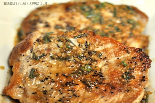 Lemon, wine and herb sauce is served on top of seared pork chops.