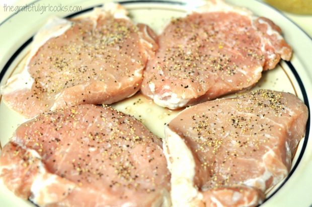 Boneless pork chops are seasoned with salt and pepper.