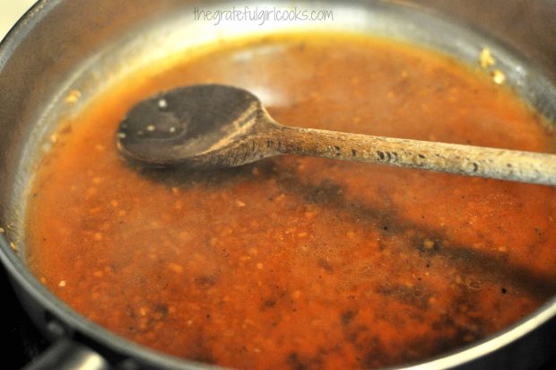 Wine and chicken broth added to skillet for sauce for seared pork chops.