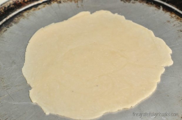 Free-form galette crust made with pie dough, on baking sheet