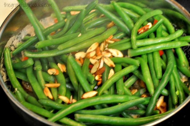 Toasted almonds are added to the skillet with the brown butter green beans.