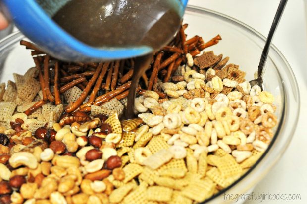 Sauce added to chex mix in bowl, then stirred to blend.