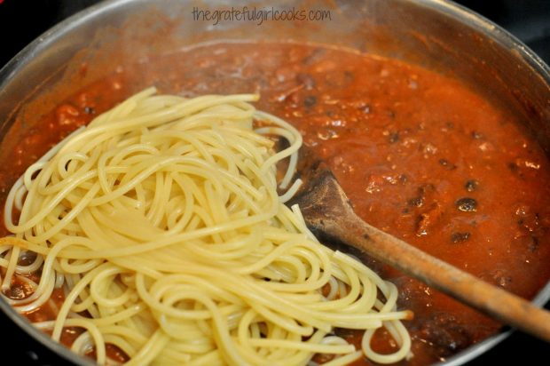 Cooked pasta is added to chili to make chili spaghetti.