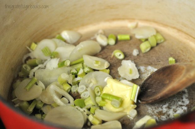 Leeks are cooked in butter to begin making creamy potato leek soup.