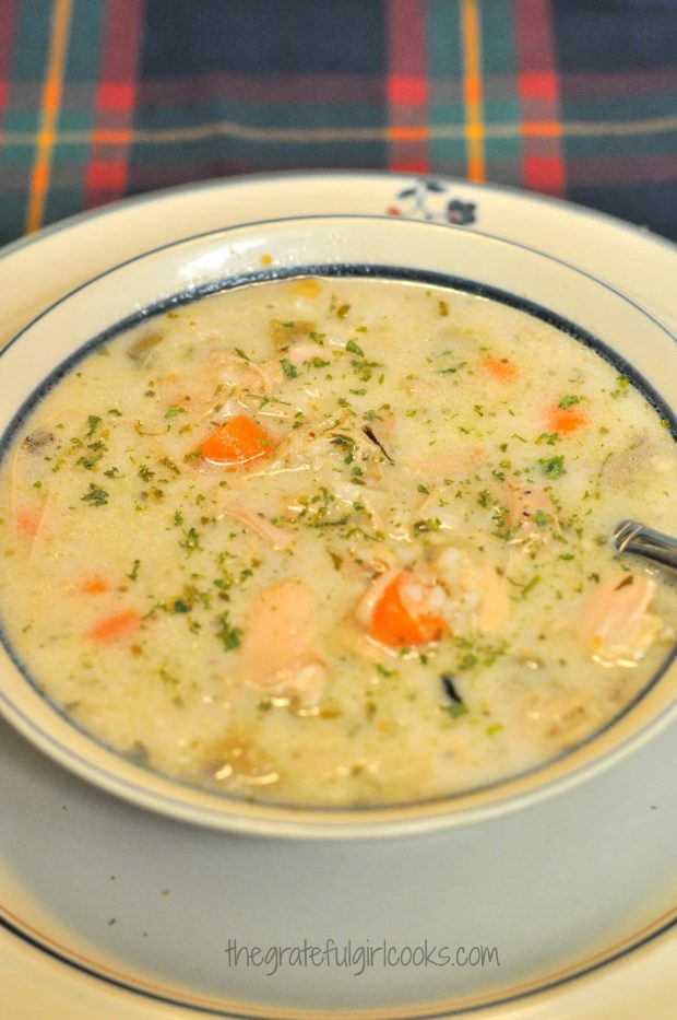 Creamy turkey wild rice soup is served in bowl.