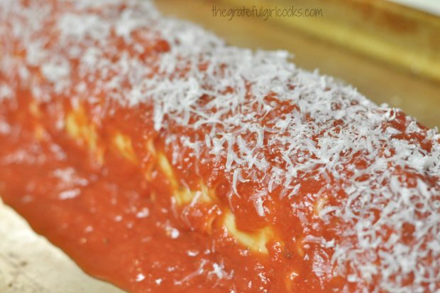 Pasta roll is covered with Italian tomato sauce and Parmesan cheese