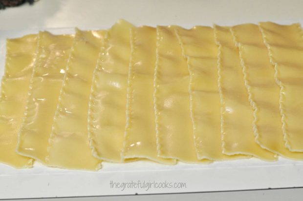 Cooked lasagna noodles are layered into a rectangle shape