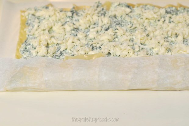 Lasagna noodles and filling are rolled up, using wax paper