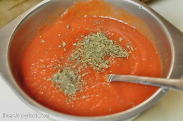Italian tomato sauce is mixed together for lasagna rolls