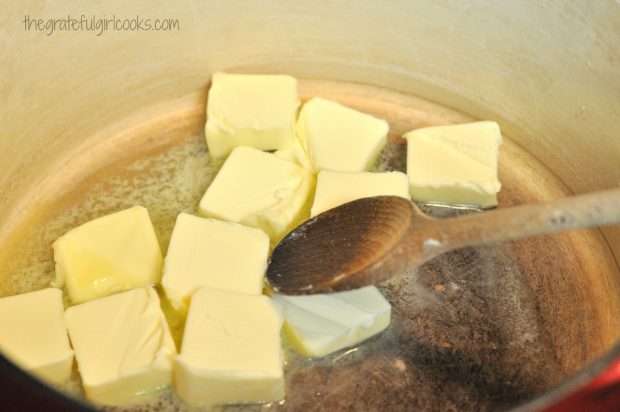 Butter is melted in a large, heavy pan.