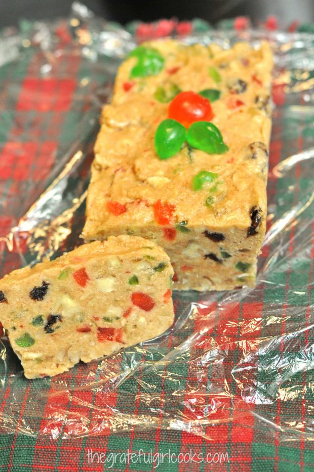 Mom's refrigerator fruitcake garnished with candied cherries, and sliced to serve.