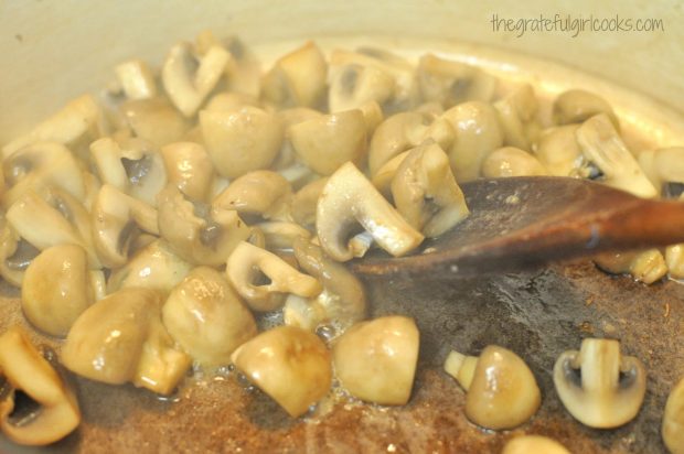 Stirring sliced mushrooms for risotto in pan