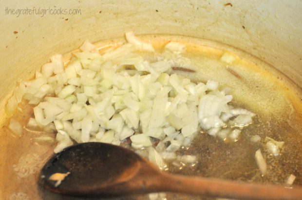 Sautèeing chopped onions for risotto in saucepan