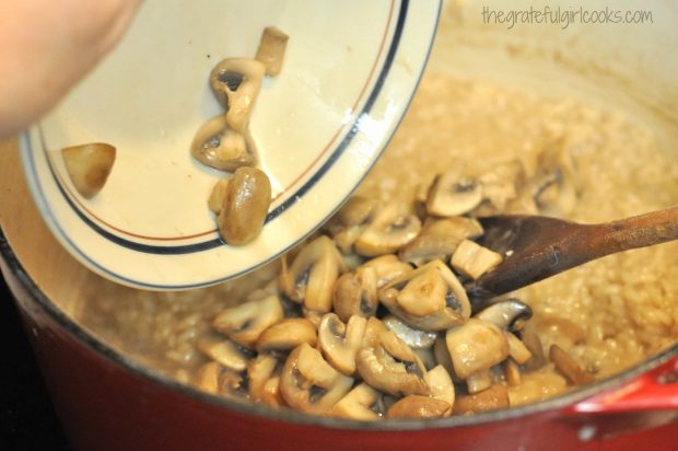 Cooked mushrooms added to risotto in saucepan