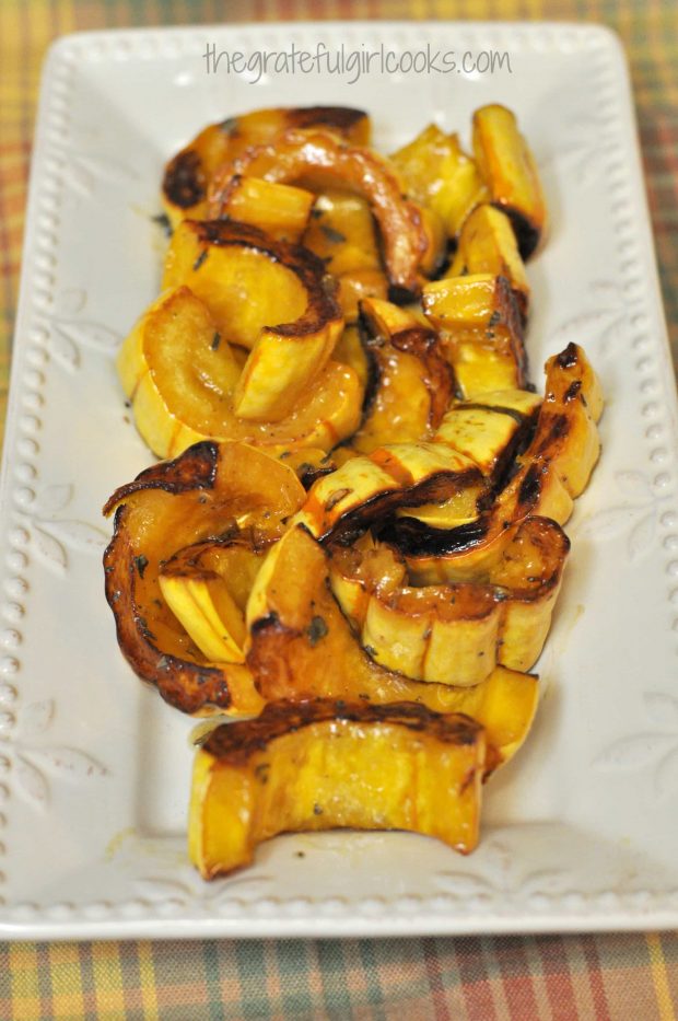 Roasted Delicata Squash with Maple and Sage, served on a white platter.