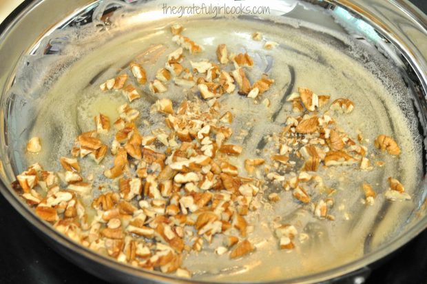 Cooking chopped pecans in butter for chicken cutlets with pecan sauce.