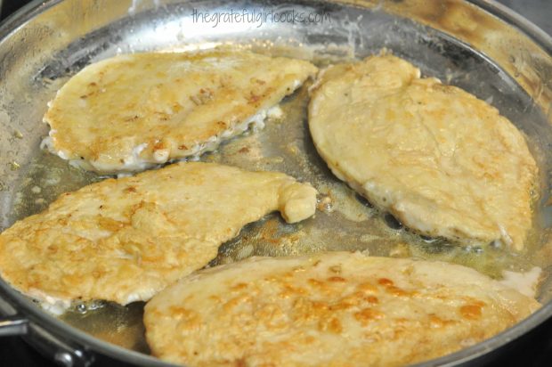 Chicken cutlets are cooked on both sides in skillet until lightly browned.