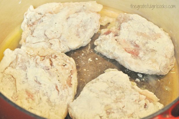 Thighs are seared in pan for chicken thigh osso bucco.