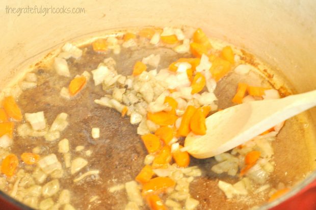 Diced carrots and onions cooked in large saucepan, for chicken thigh osso bucco.