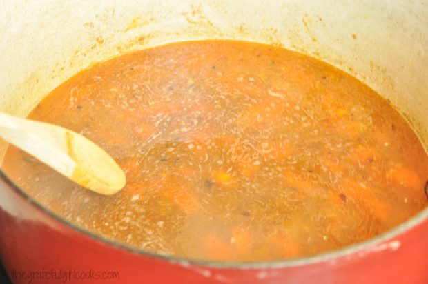 Sauce is cooking for chicken thigh osso bucco dish.