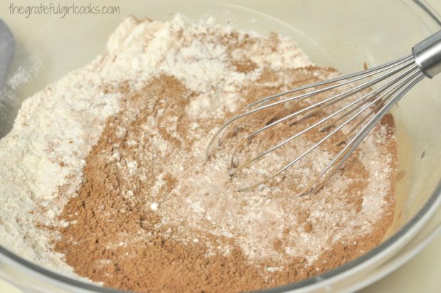 Flour and cocoa for chocolate muffins in mixing bowl with whisk