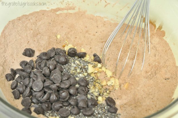 Chocolate chips and almonds added to dry ingredients for chocolate almond chia muffins.