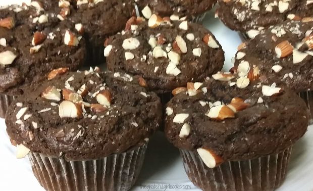 Close up of dark chocolate almond chia muffins, with almonds on top