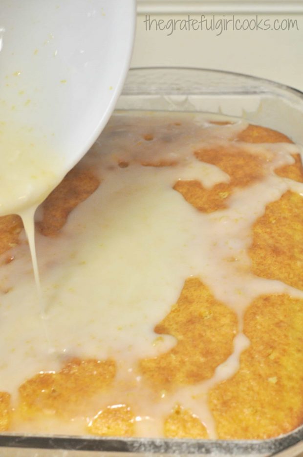 Glaze is poured over top of lemon jello cake.