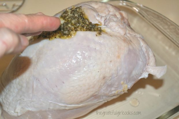 Spices with garlic and herbs are rubbed onto turkey breast before roasting