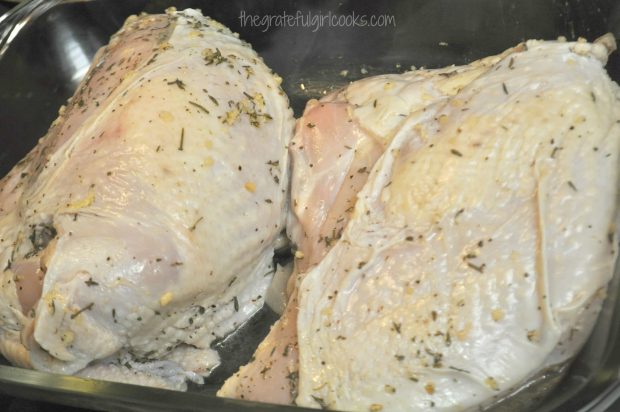 Roast turkey breast is split in half before putting into oven.