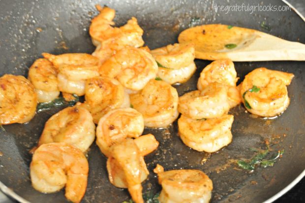 Pan-seared shrimp are cooked to add to the tacos.