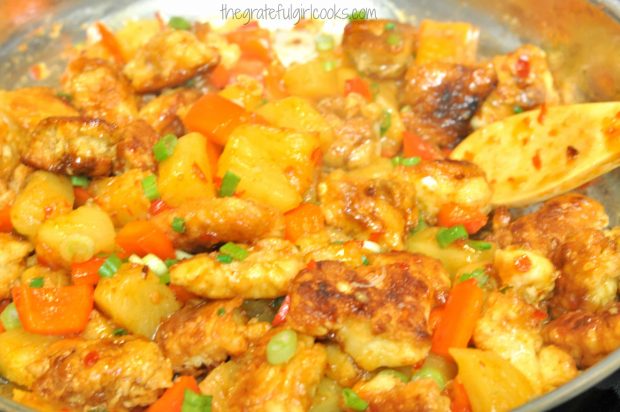 Browned chicken is added to the sauce in skillet, to make sweet fire chicken.