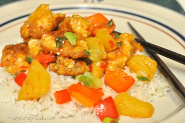 Sweet fire chicken is served on top of white rice.