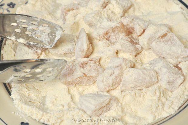 Chicken breast cubes are dredged in flour before cooking them for sweet fire chicken.