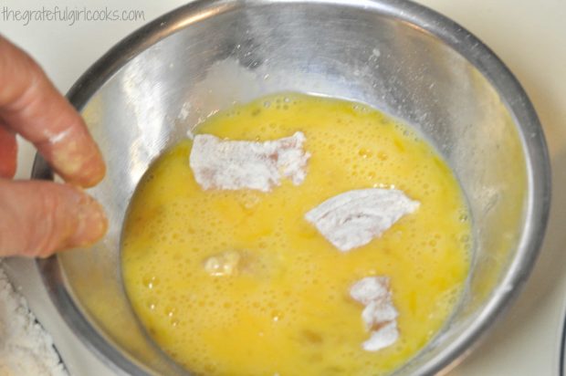 Flour coated chicken (for sweet fire chicken) is dipped in egg mixture before cooking.