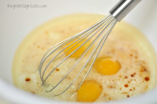 Whisking wet ingredients (oil, eggs, extract, etc.) in bowl