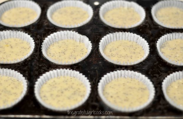 Batter in paper-lined muffin cup holders