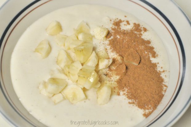 Waffle batter in bowl with bananas and cinnamon