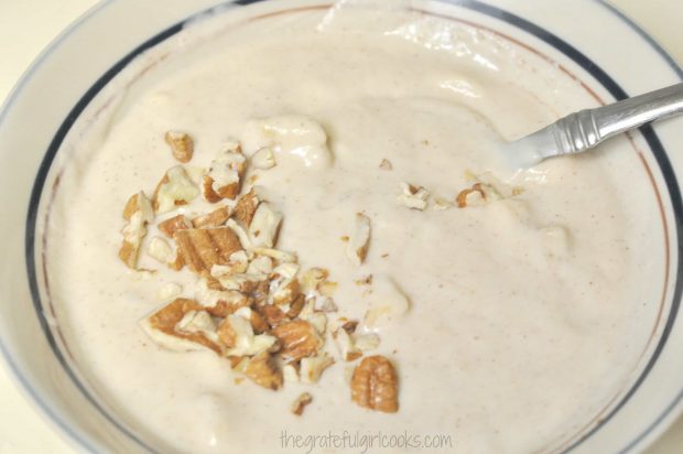 Chopped pecans added to waffle batter in bowl