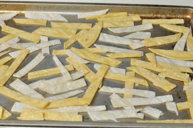 Tortilla strips for Chili's chicken enchilada soup are baked on cookie sheet until crispy.