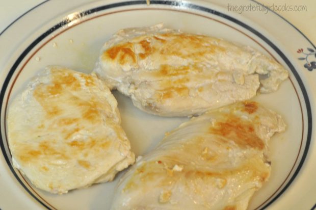 Browned, cooked chicken breasts on plate