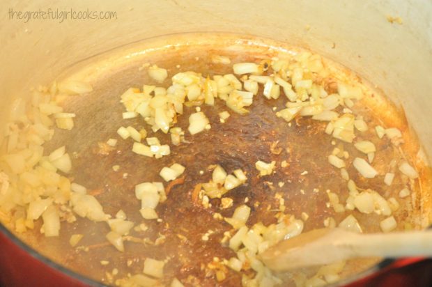 Chopped onions and garlic, cooking to add to soup