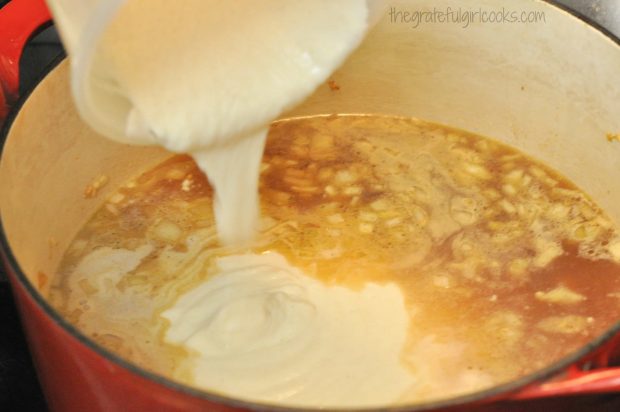 Masa harina and chicken broth added to chicken enchilada soup mixture in saucepan.