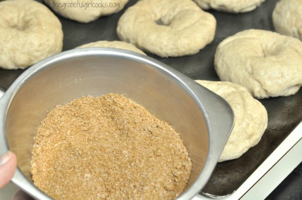 Before they bake the bagels are topped with cinnamon sugar mixture.