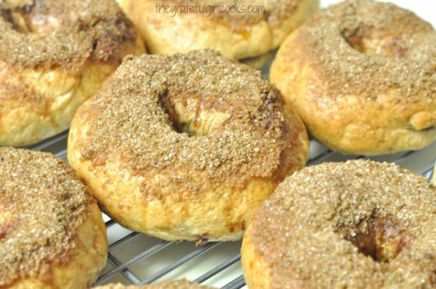 After baking, the cinnamon crunch bagels cool on a wire rack.