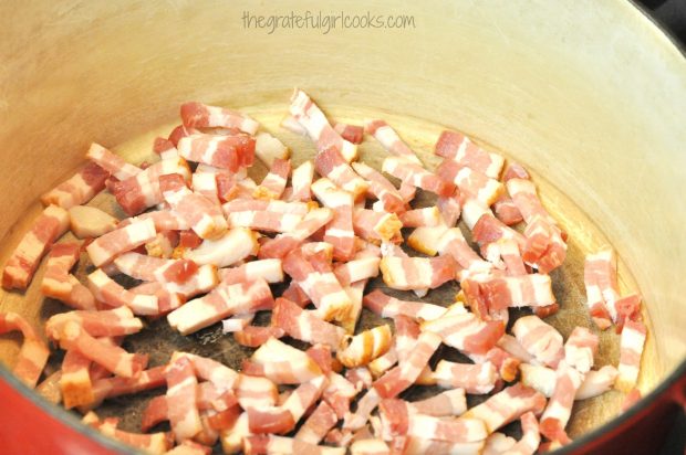 Bacon pieces are cooked in large soup pot.