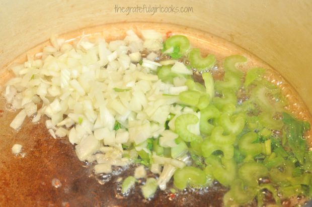 Chopped onions and celery are cooked in bacon drippings before adding to corn chowder.