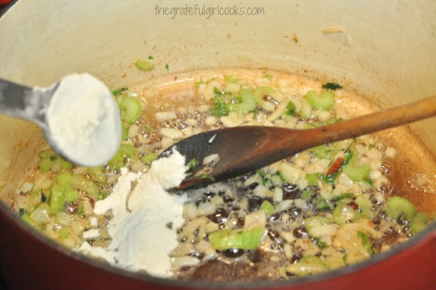Flour is added to cooked onions and celery to help thicken corn chowder.