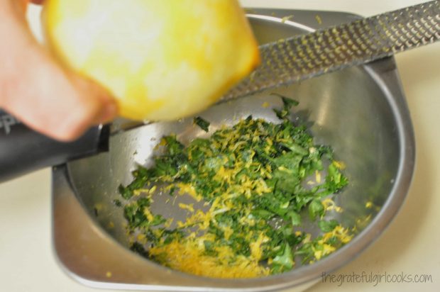 Lemon zest and parsley added to bowl for chicken marinade