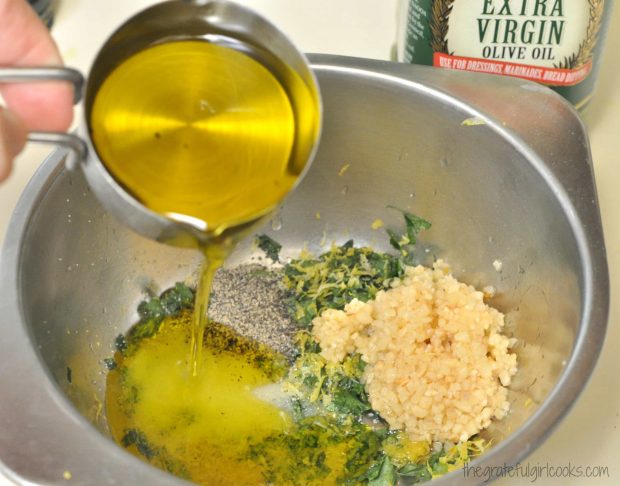Olive oil is added to garlic, parsley and lemon zest for kabob marinade